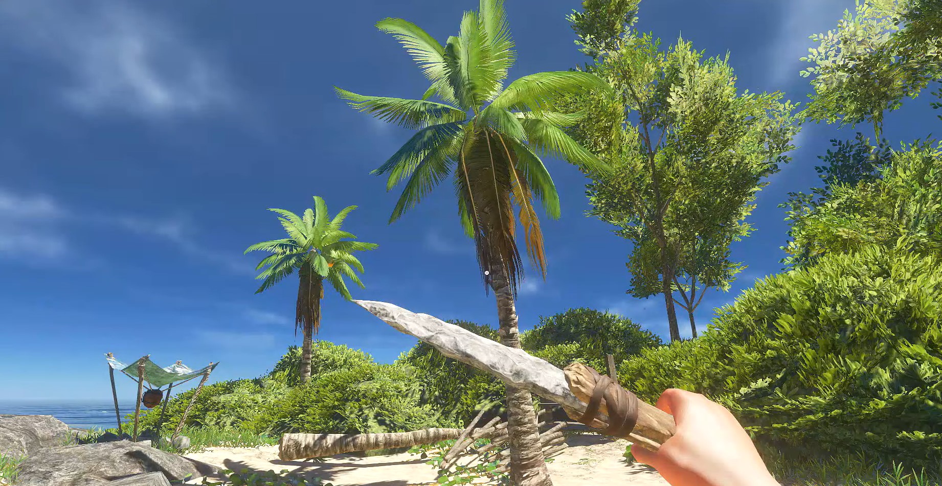 Stranded Deep holding knife in front of palm tree