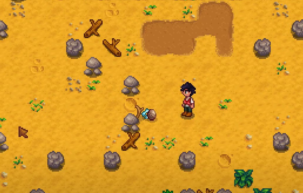 How to drop items in Stardew Valley - player dropping items in sandy area